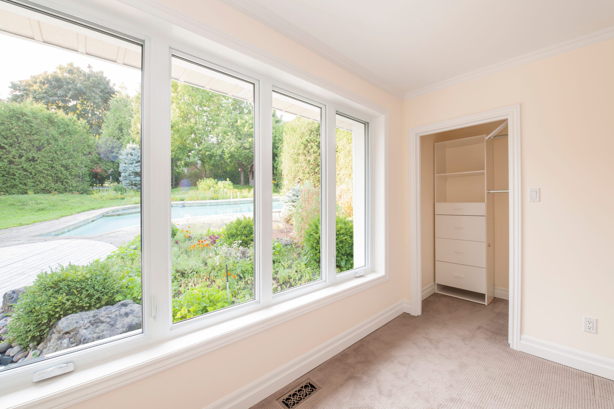 Large picture windows overlooking green yard