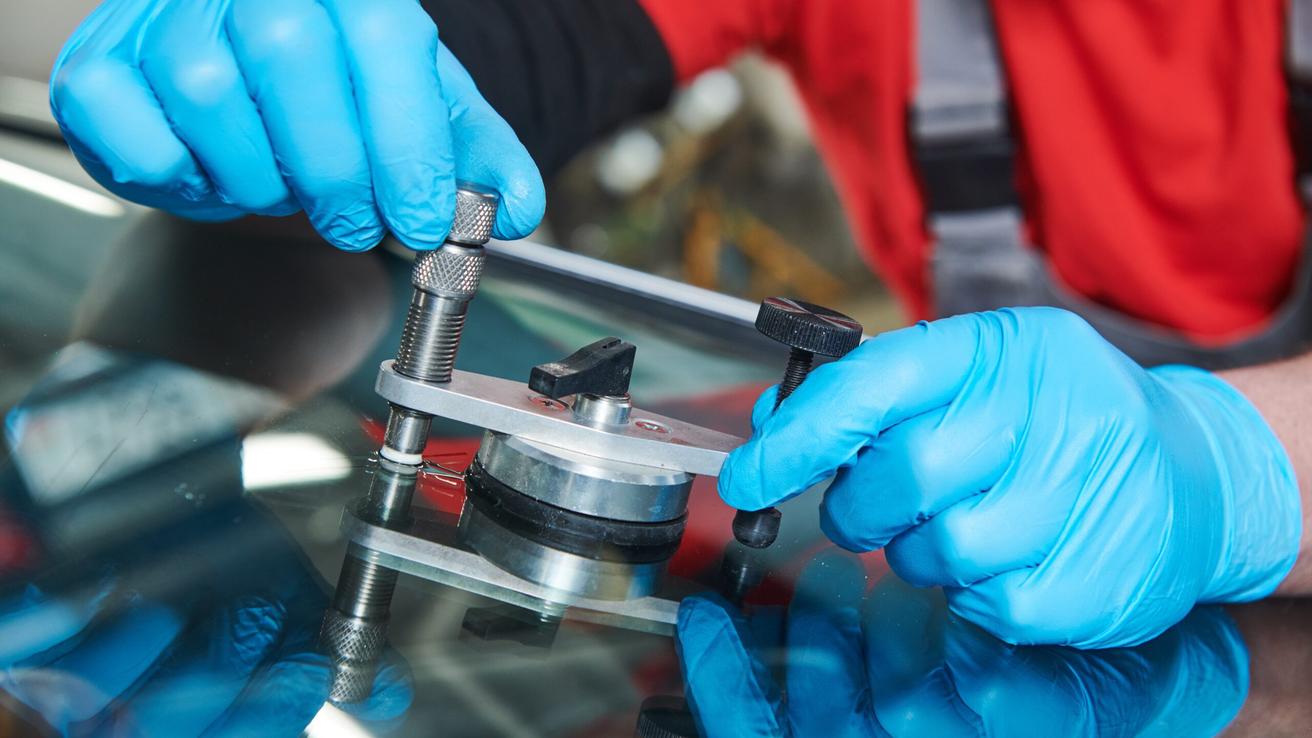 Windshield Chip being Repaired with a specialized tool 
