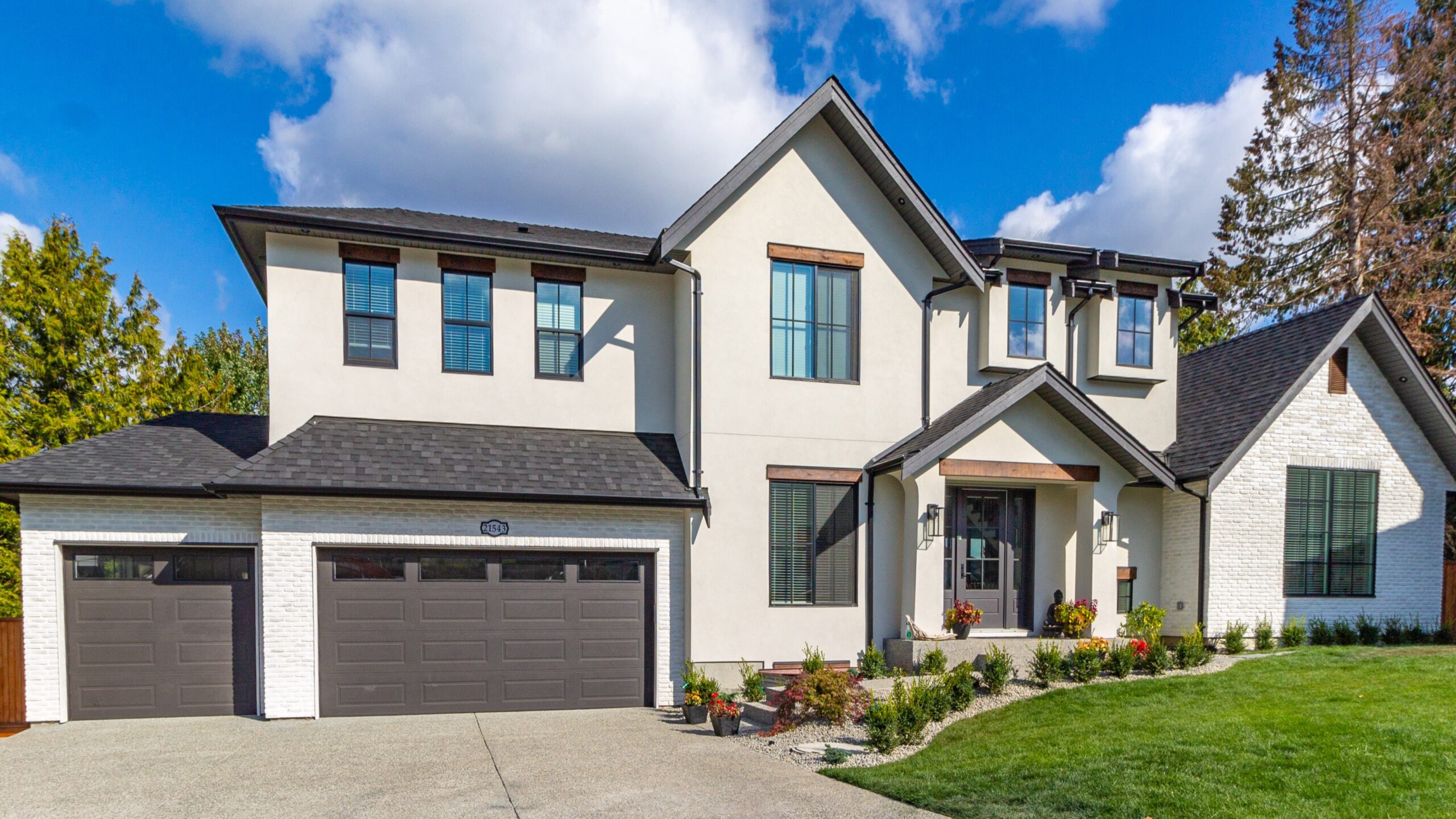 Large modern home with white brick siding with lots of new beautiful windows